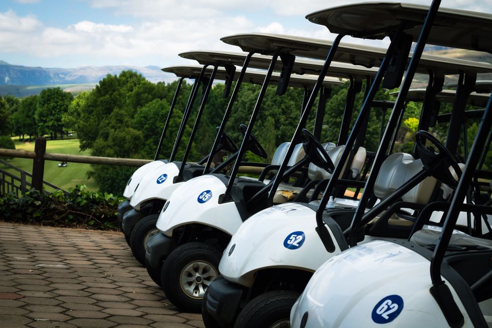 Golf carts parked on a green course