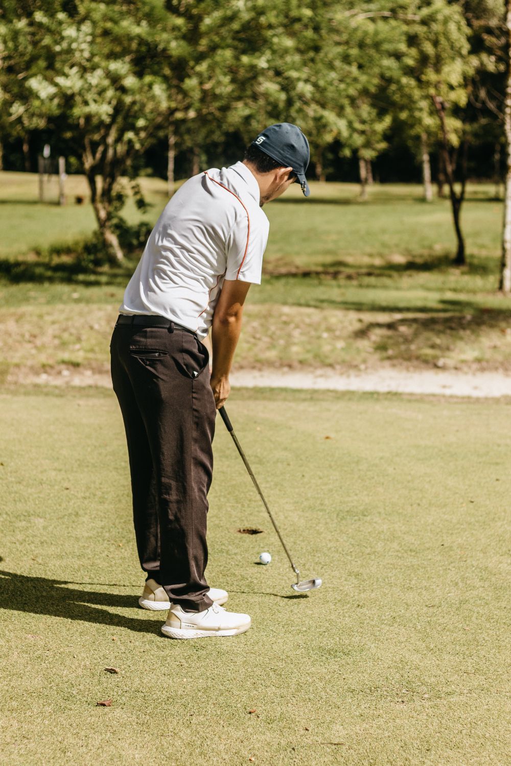 Golfer putting on the course